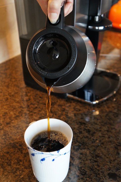 The Mr. Coffee features a stainless steel carafe with thumb-activated pouring.